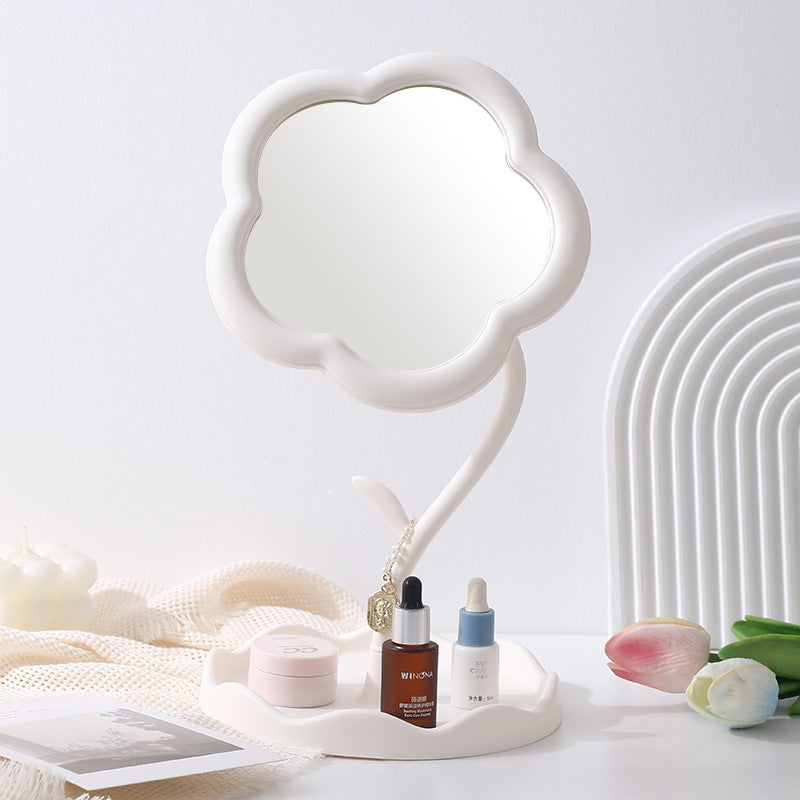White flower-shaped tabletop mirror on a pale vanity